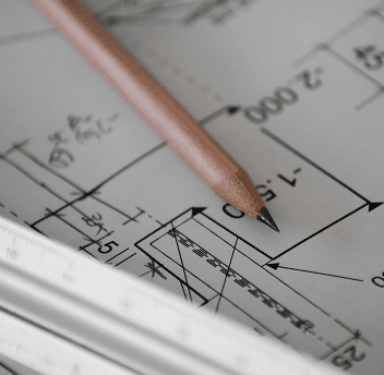 A pencil and ruler on a blueprint.