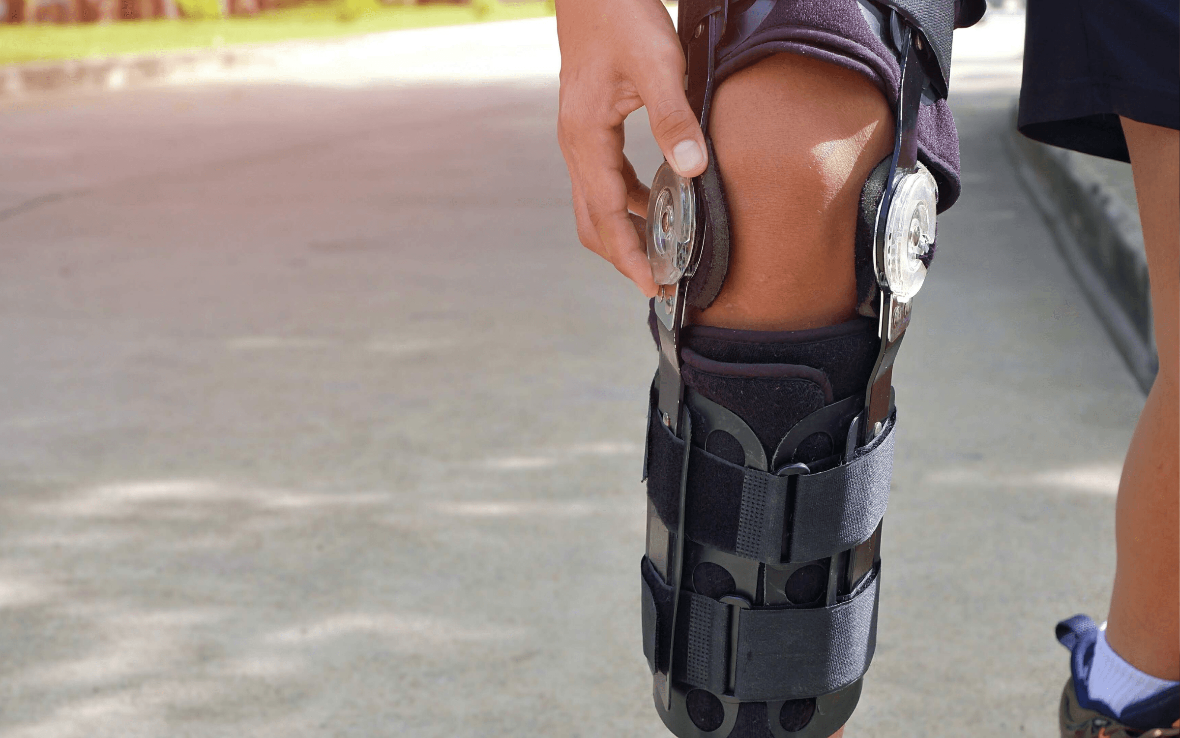 Photo of a healthcare professional in scrubs discussing information on a tablet with a seated patient.