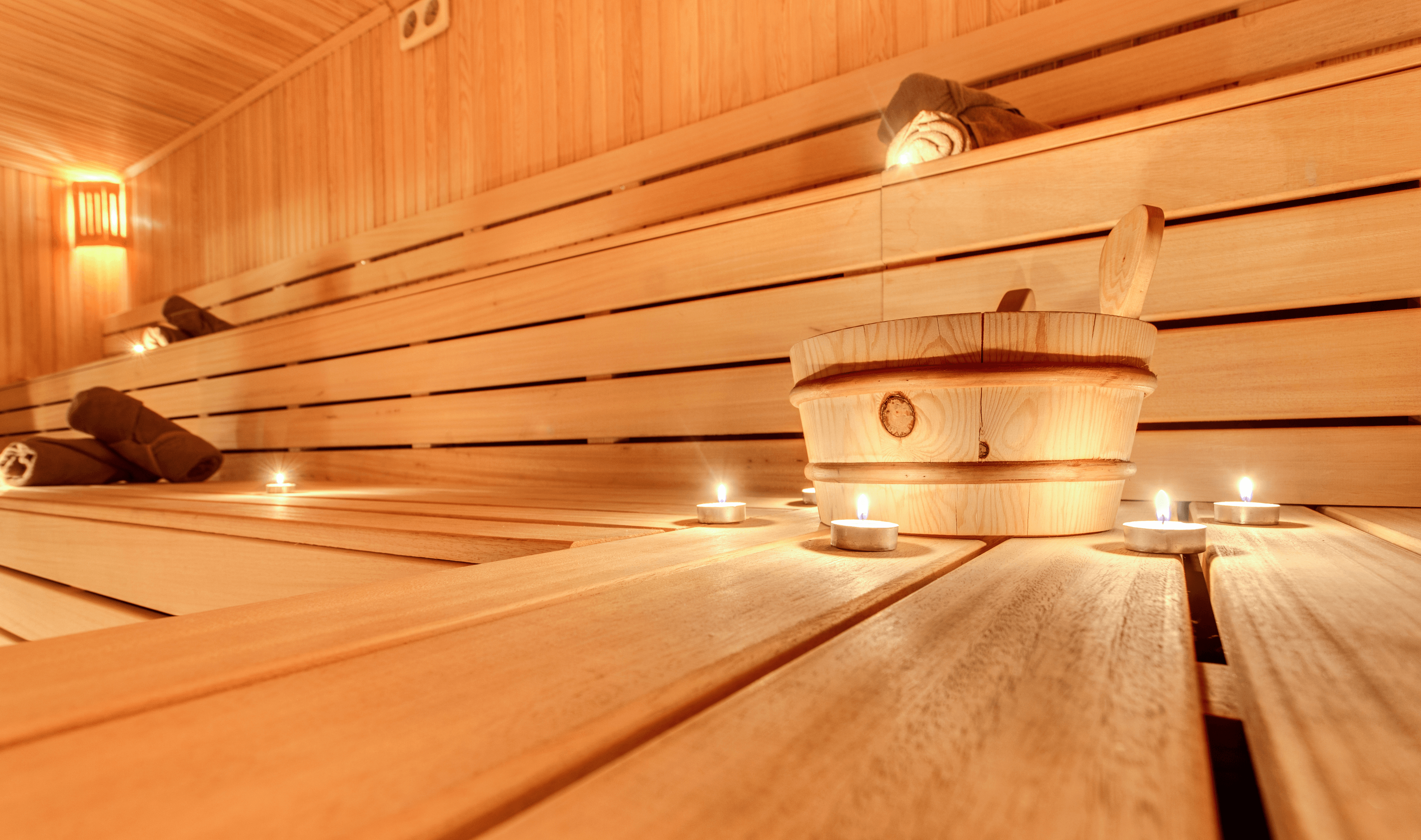 Photo of a wooden sauna interior featuring benches and paneled walls, designed for relaxation and heat therapy.