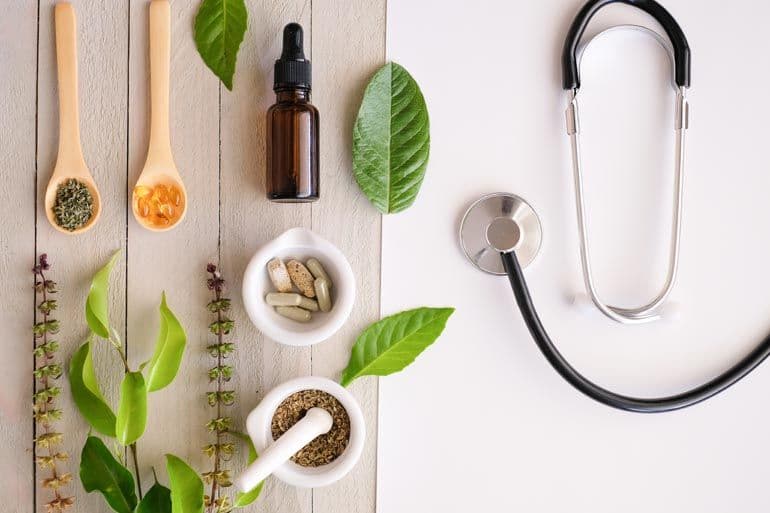 A photo of natural remedies, supplements, and a stethoscope, representing integrative or holistic healthcare.